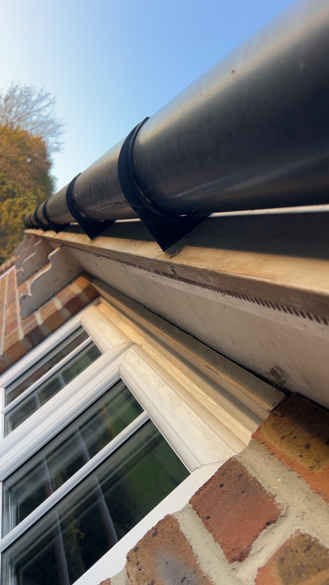 Black guttering on brick building