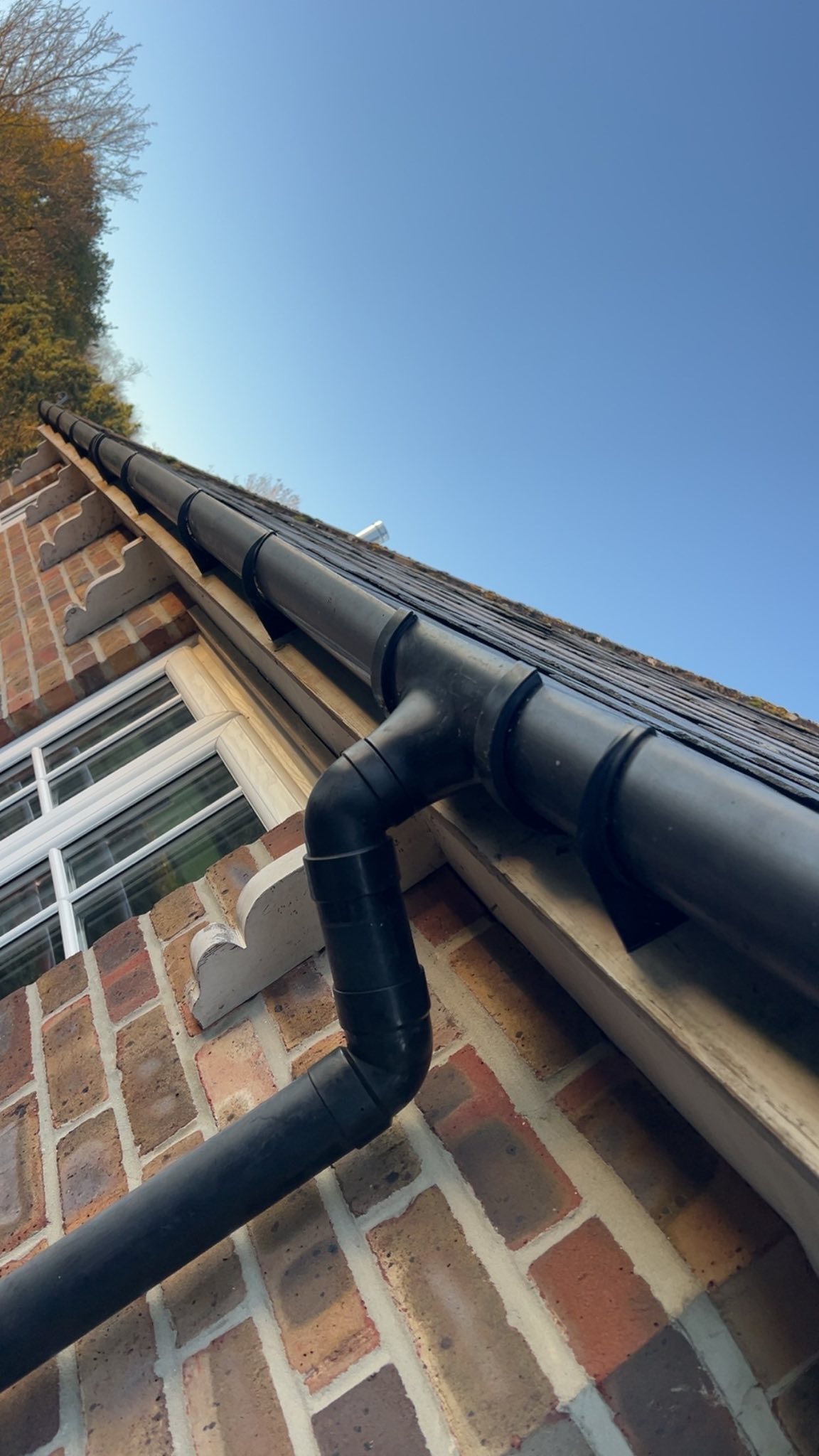 Black guttering on brick house